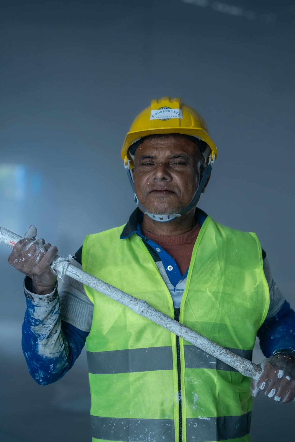 Commercial painter with roller inside a jobsite Commercial painter with roller inside a jobsite
