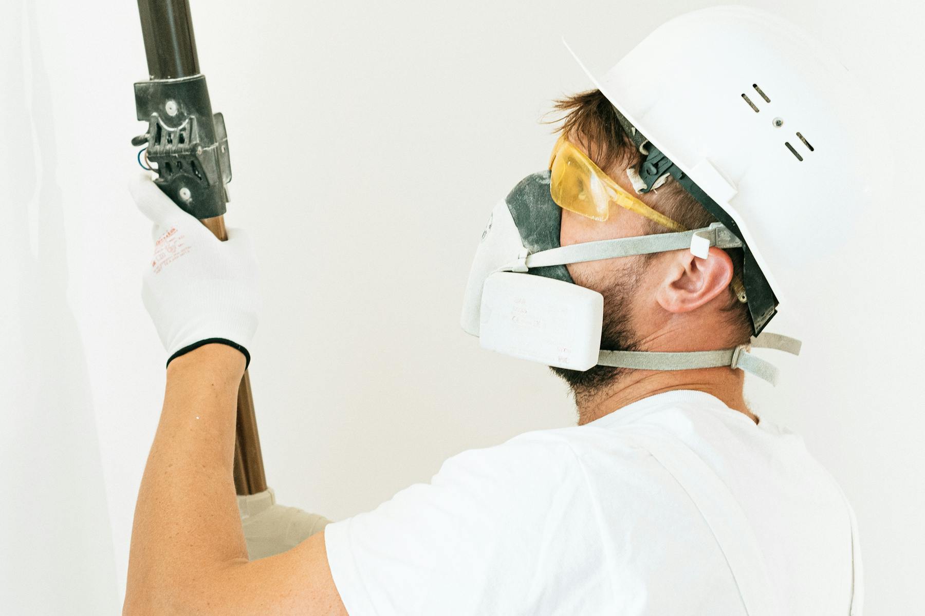 Commercial painter preparing an occupied-space repaint